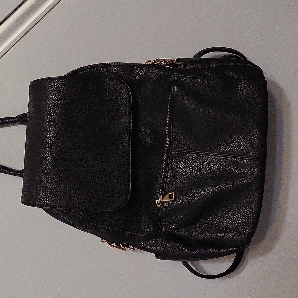 Black mini backpack with lots of pockets.